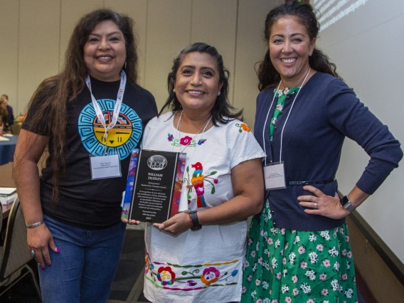 Alma Ramirez (center) receiving award.