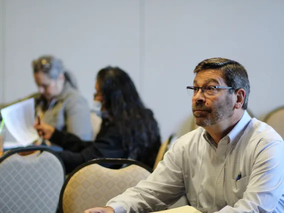 Conference participant listening to a speaker 