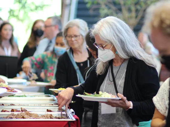 Attendees line up for lunch.