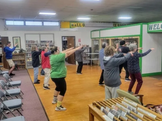 group of people doing Tai Chi in a library