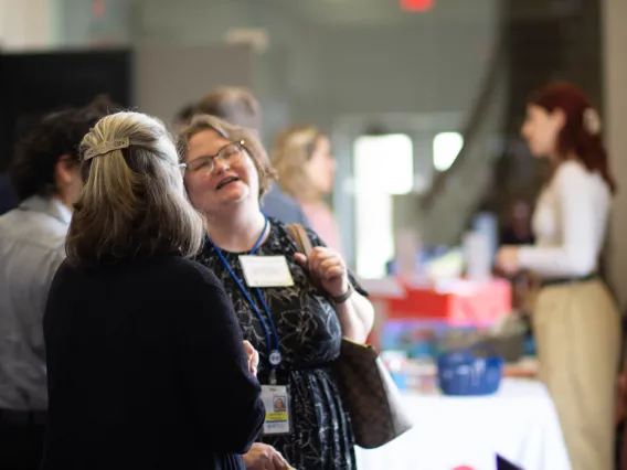 Attendees share a laugh with the vendor tables
