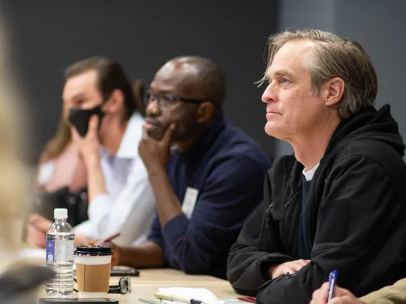 three men listening to a breakout session