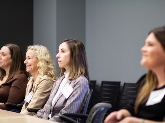 four women attend a breakout session 