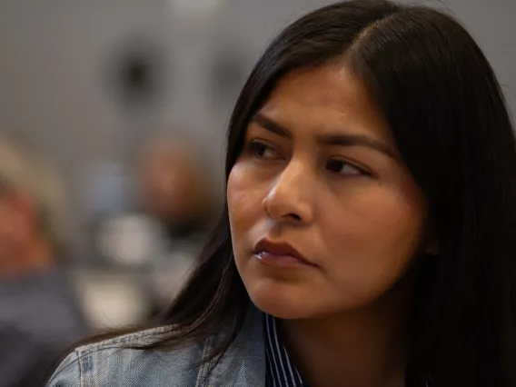 an attendee at a conference listens to a speaker