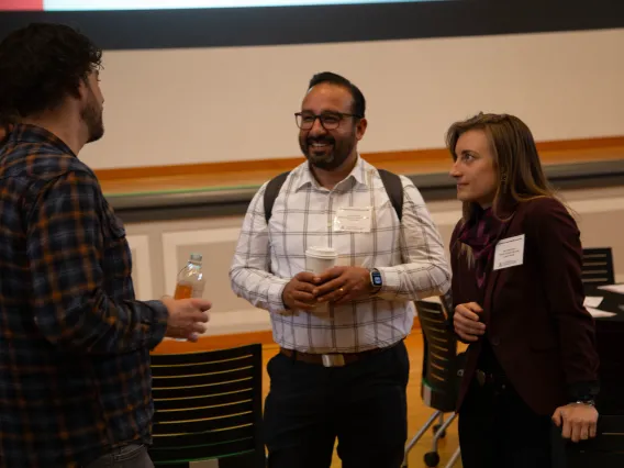 two people listen to a third person speaking