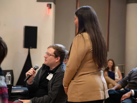 a man holds a microphone to ask a question