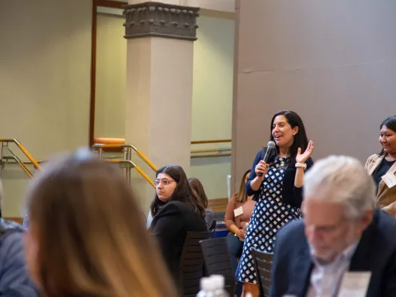 Tara Sklar holds a microphone in the audience