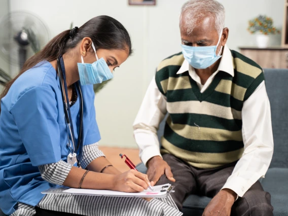 doctor with patient man in a sweater vest