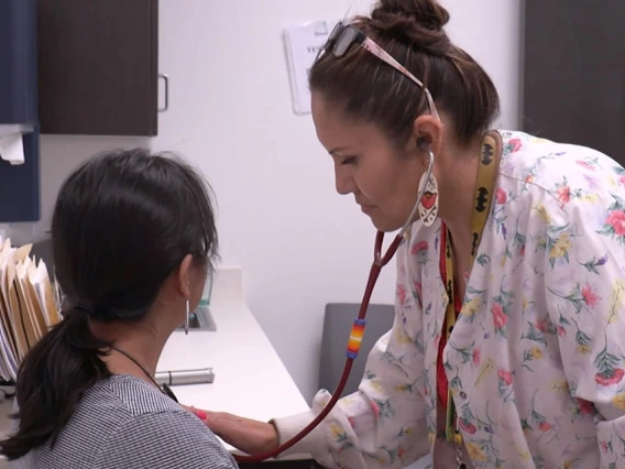 doctor listens to patients heart