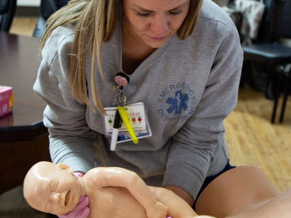 Emergency department nurse practicing hand maneuvers for delivery 