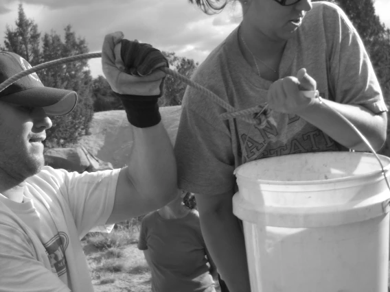 RHPP service learning students carrying bucket