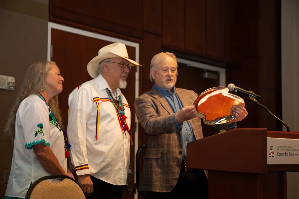 Dan Derksen presents a Nambe platter to Dr. Carlos Gonzales.