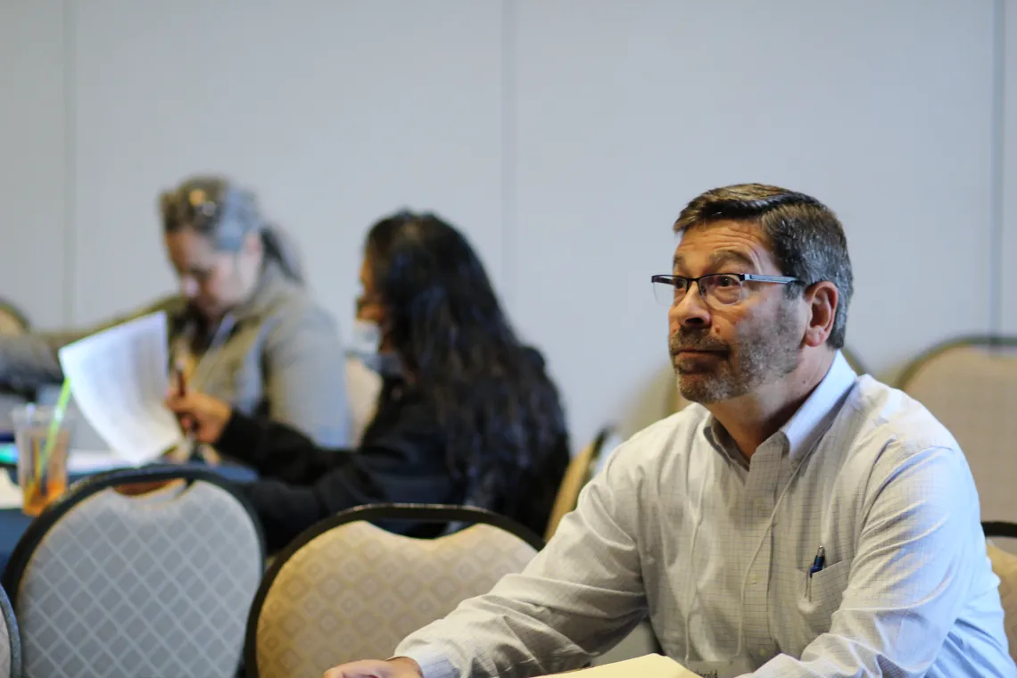 Conference participant listening to a speaker 