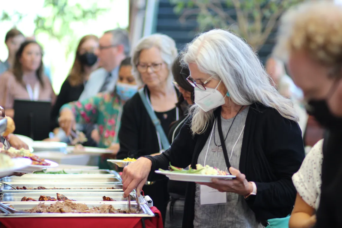 Attendees line up for lunch.