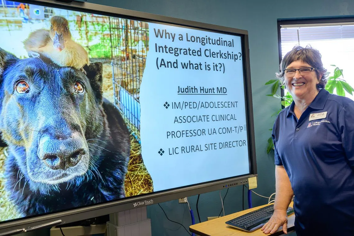 Dr. Hunt, regional site director for the University of Arizona College of Medicine – Phoenix’s Rural Health Longitudinal Integrated Clerkship, in front of a display