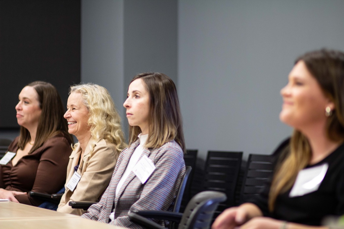 four women attend a breakout session 