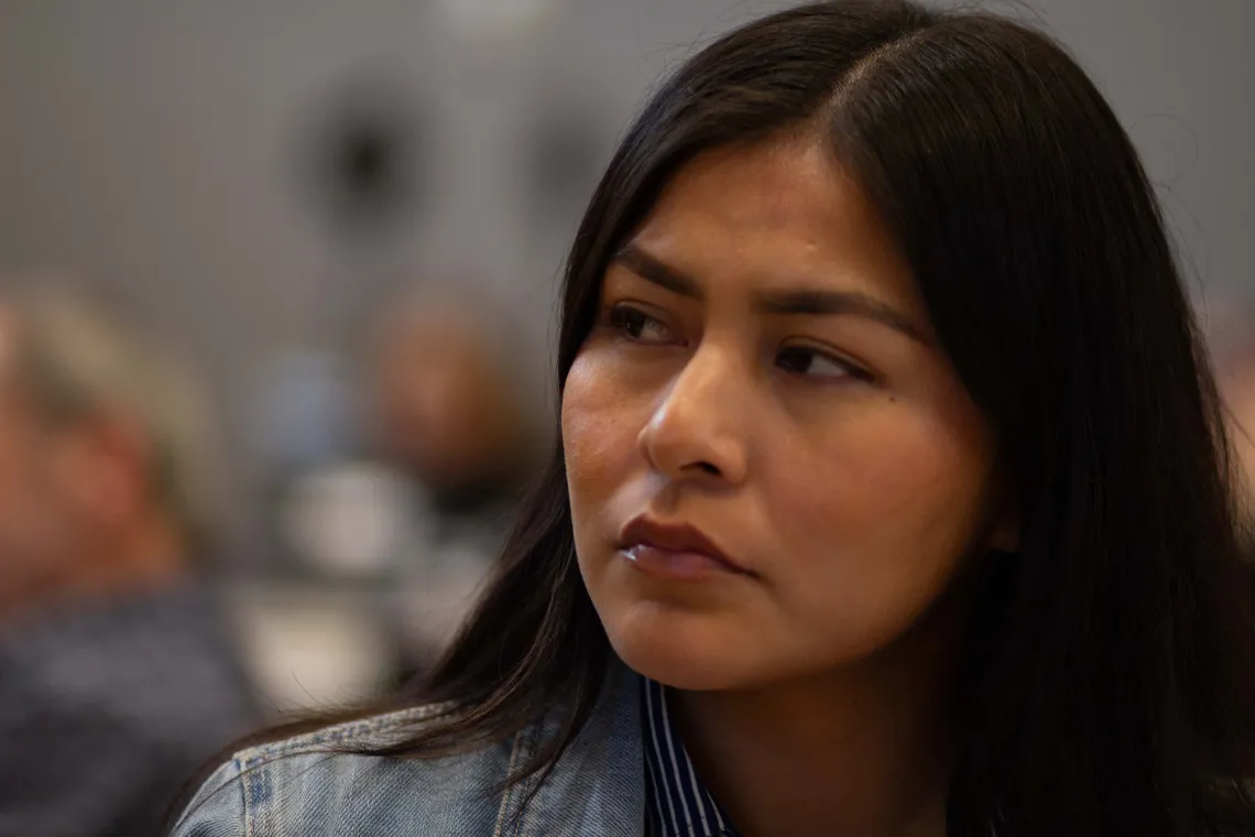 an attendee at a conference listens to a speaker