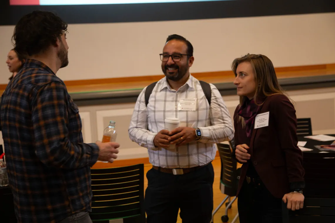 two people listen to a third person speaking