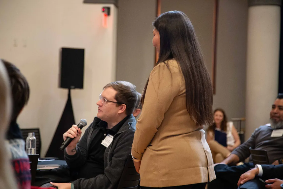 a man holds a microphone to ask a question