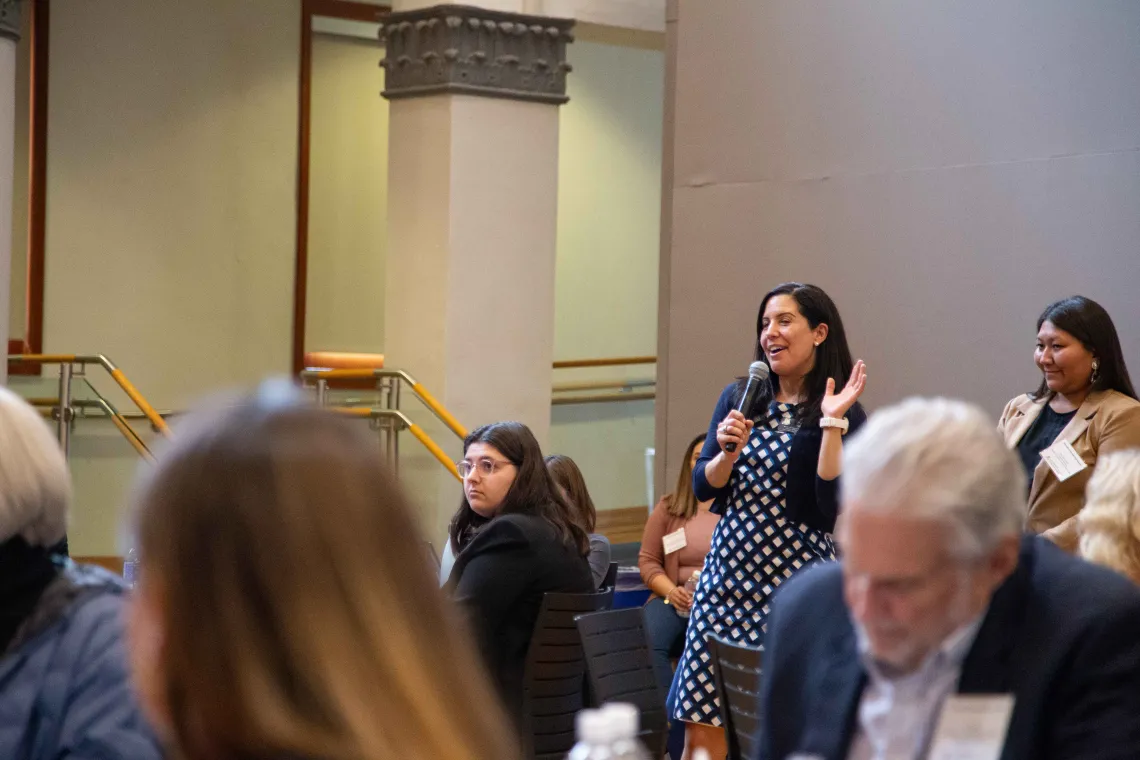 Tara Sklar holds a microphone in the audience