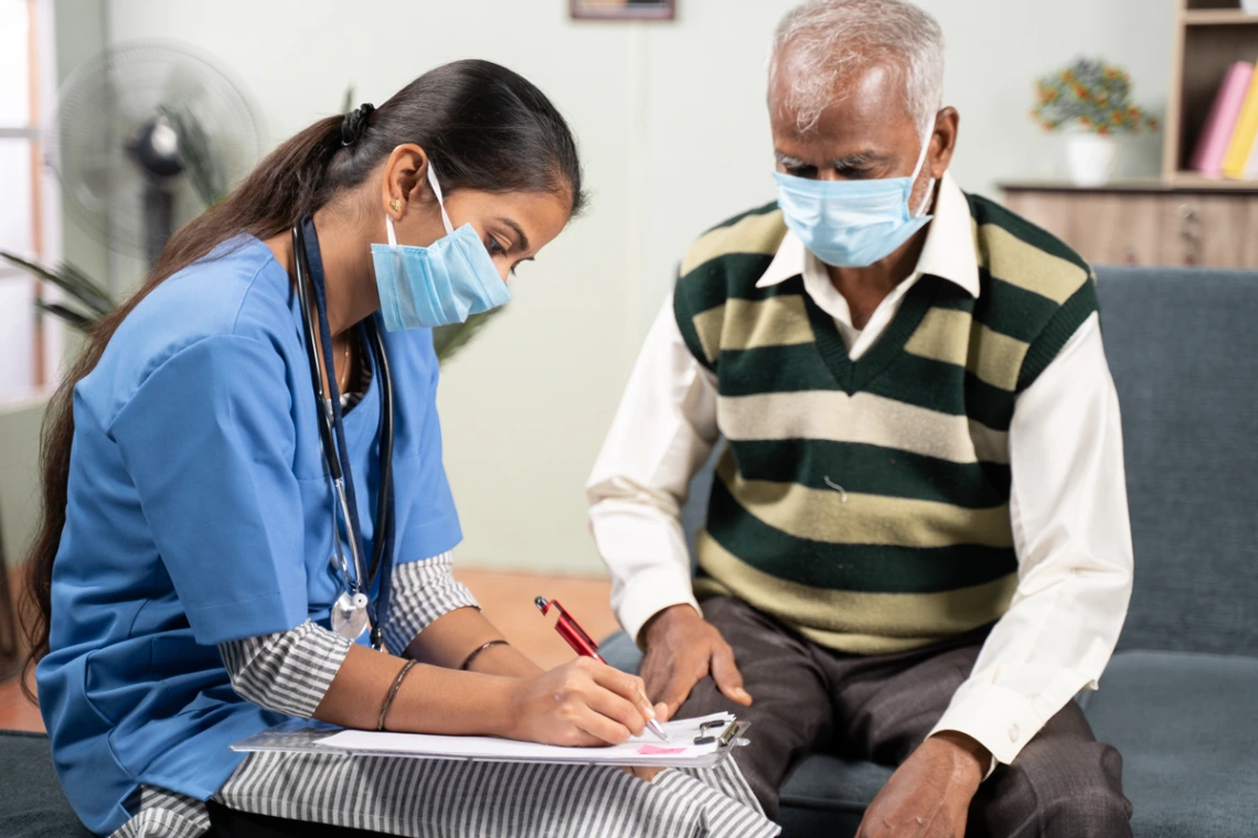 doctor with patient man in a sweater vest