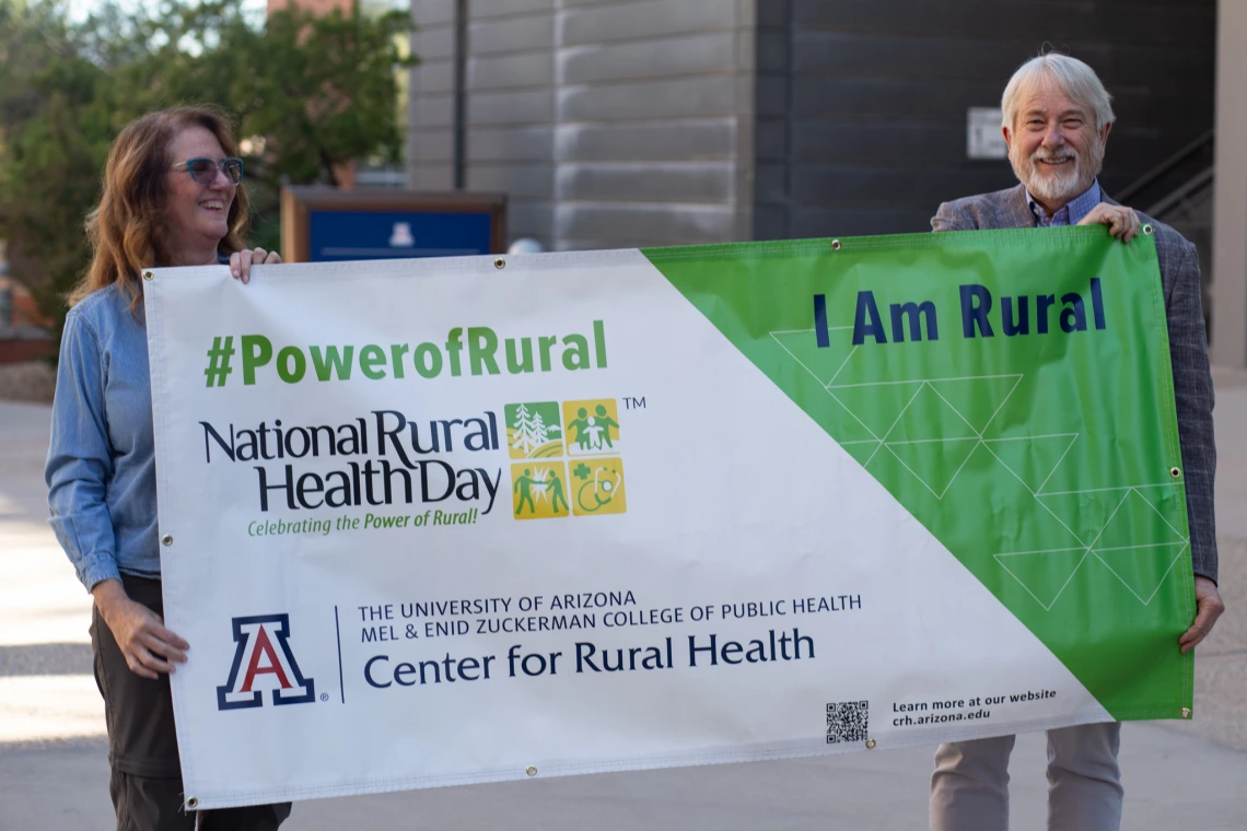 Jill Bullock and Dan Derksen with National Rural Health Day sign