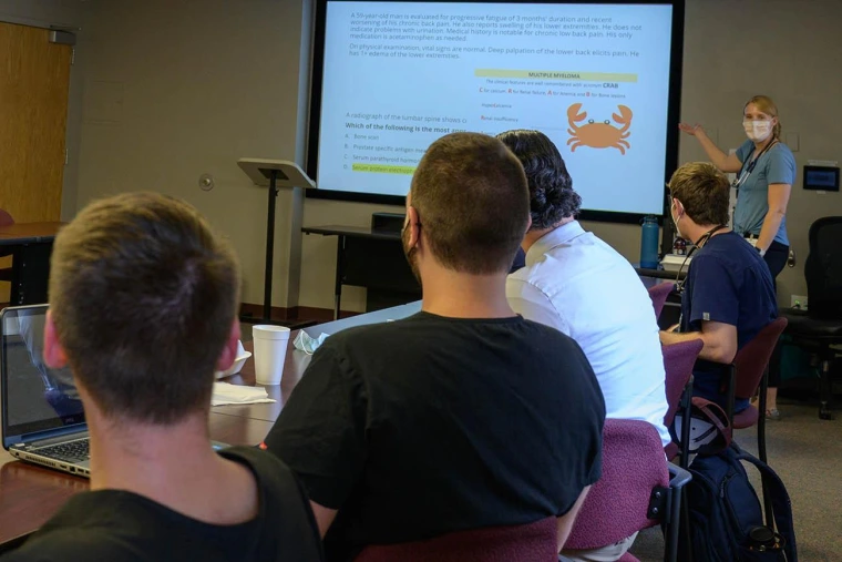 students listen to instructor in the classroom