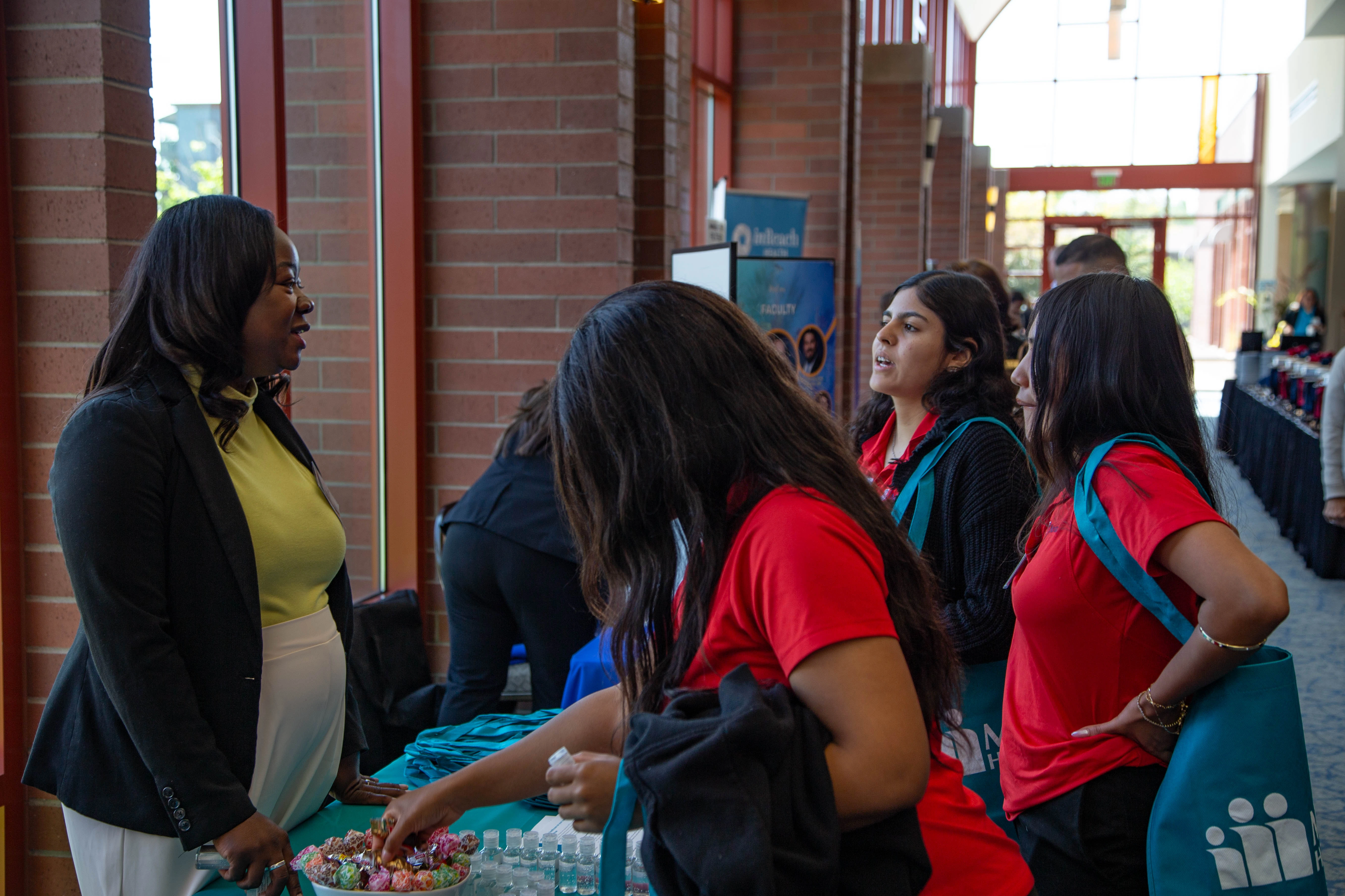 U of A College of Nursing students talk with a vendor