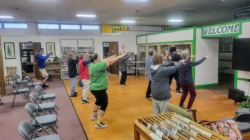 group of people doing Tai Chi in a library