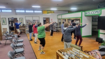 group of people doing Tai Chi in a library