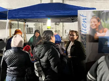 Maria Losoya speaks with a consumer at an outreach event