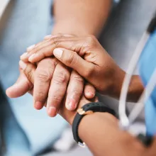 Dr. holding a patients hands