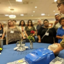 woman demonstrates naloxone administration with mannequin 