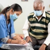 doctor with patient man in a sweater vest